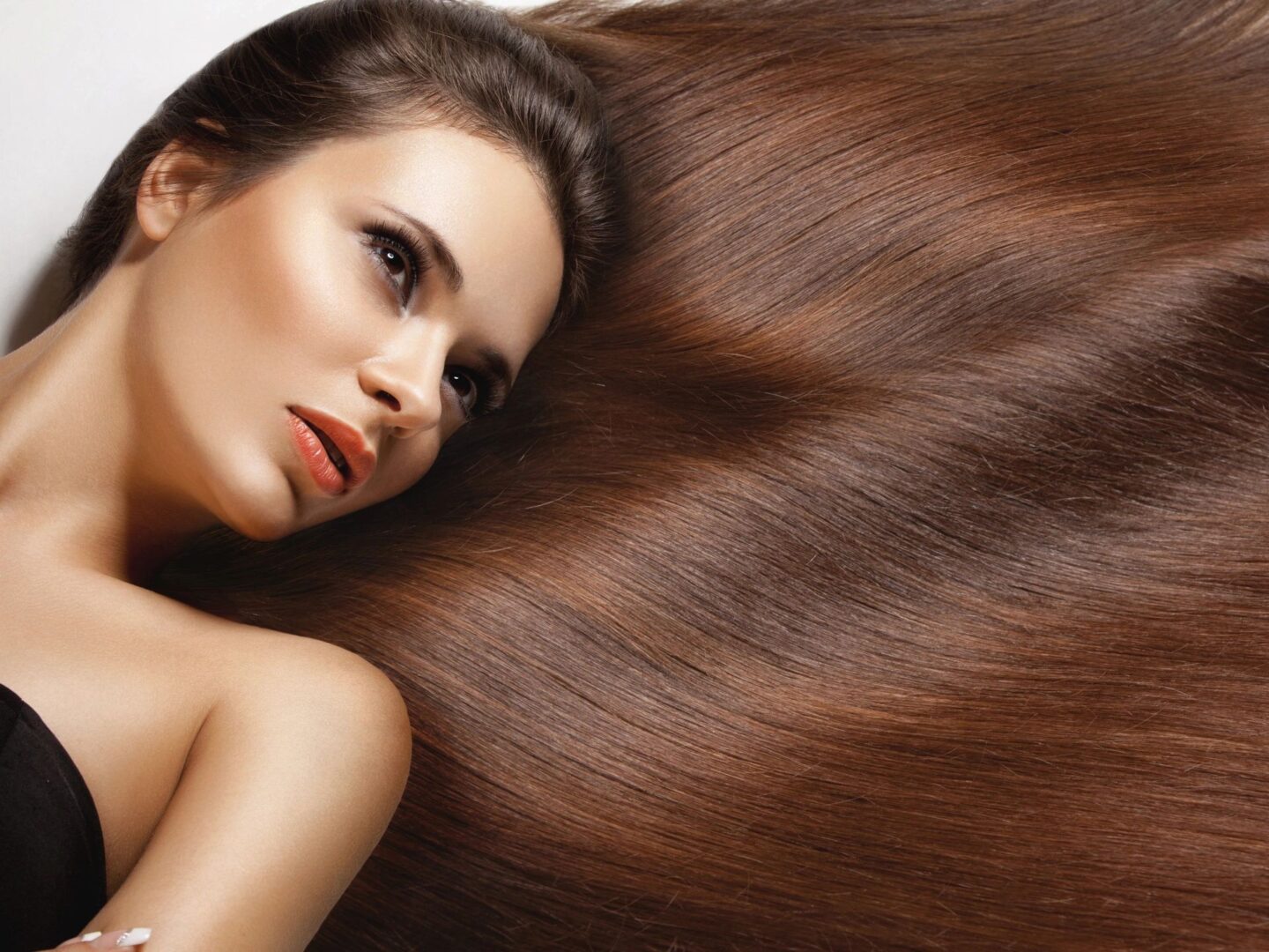 A woman laying down with long brown hair.